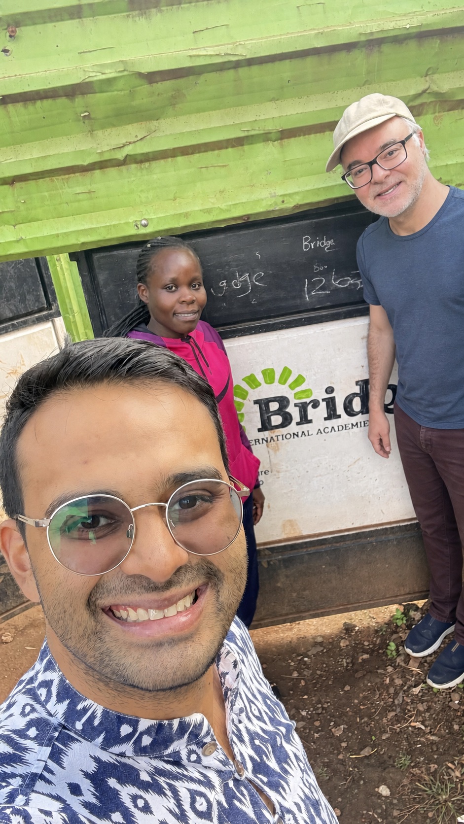 Shivad Singh of Head Start and Adrian DeWitts of Bookbot with a teacher during a visit to a Bridge International Academies school