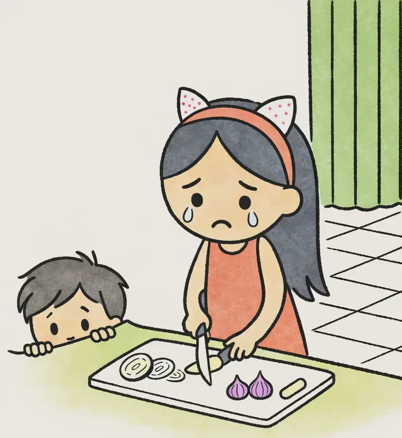 On the right side of the image, Little Brother peeks over the edge of a kitchen counter, with just his eyes and hands visible, looking up with a concerned, worried expression. He is watching Big Sis, who stands at the counter chopping onions on a cutting board — her eyes are teary and her expression looks sad. The scene is set indoors in a bright kitchen with tiled flooring and green curtains visible in the background. The left side of the image is plain white background.