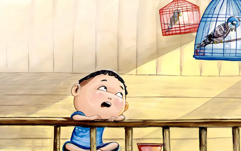 Boy looking up sadly at two birds in separate cages hanging above him, one red and one blue