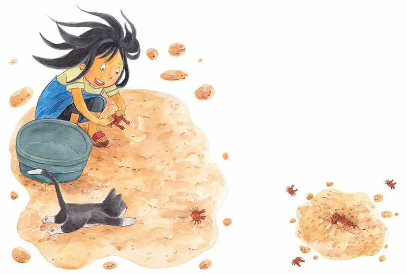 Girl with windblown hair catching crabs on beach with bucket while cat watches