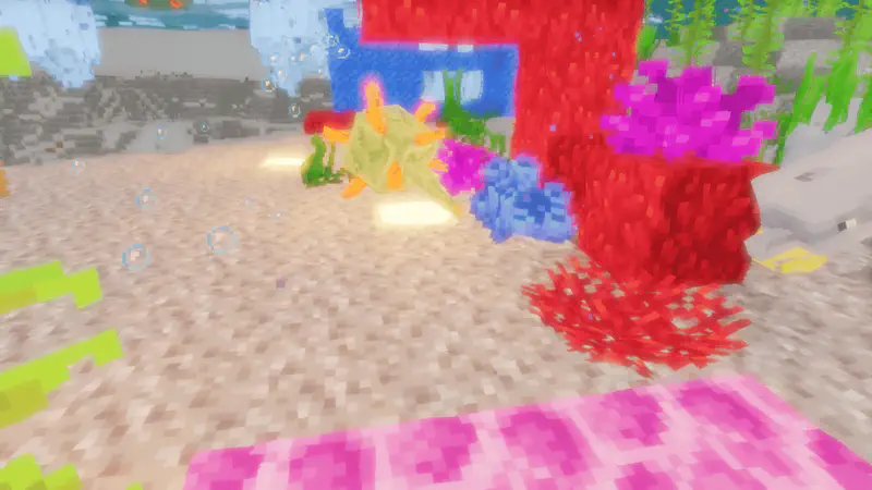 Minecraft underwater coral reef with vibrant red, pink, purple, and yellow coral formations on sandy ocean floor with bubbles rising.
