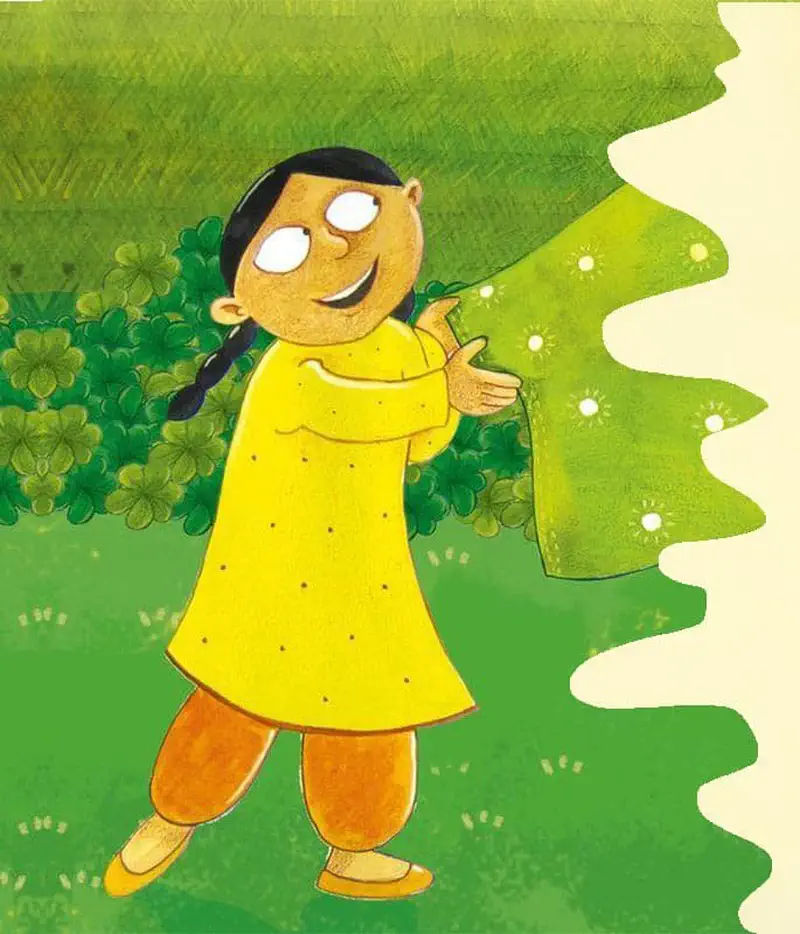 Girl in yellow dress smiling and holding green patterned fabric in garden