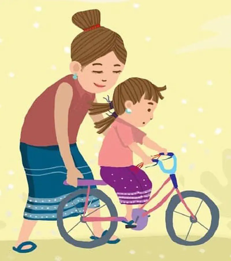 A mother helps her daughter learn to ride a pink bicycle, holding the seat to steady her as they practice together.