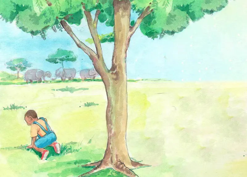 Boy sitting sadly under large tree with herd of elephants visible in distant savanna.