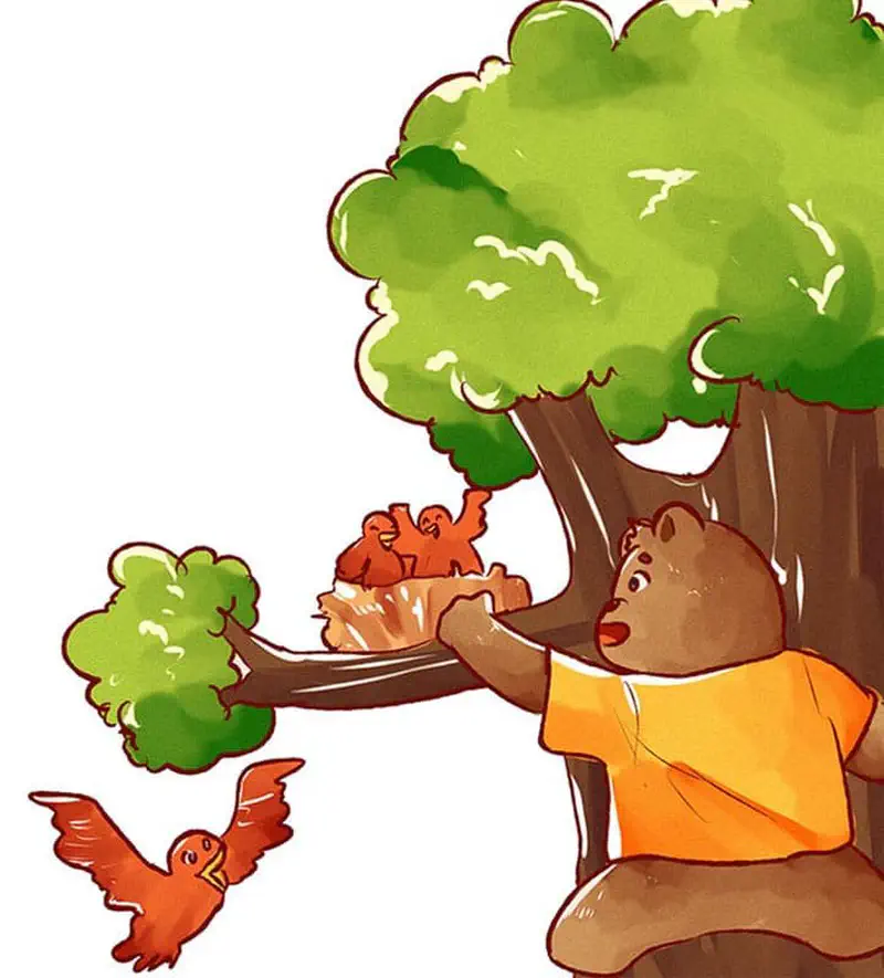 A bear in an orange shirt reaches toward a nest of baby birds in a tree while an adult bird flies nearby.