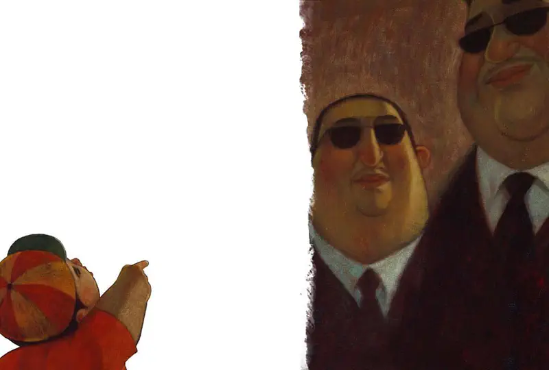 A young boy in red with a colorful cap points upward while two stern men in dark suits and sunglasses stand in the background.