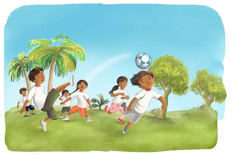 Children in white shirts play soccer on a grassy field with palm trees, one boy kicks high while others run and chase the blue and white ball.