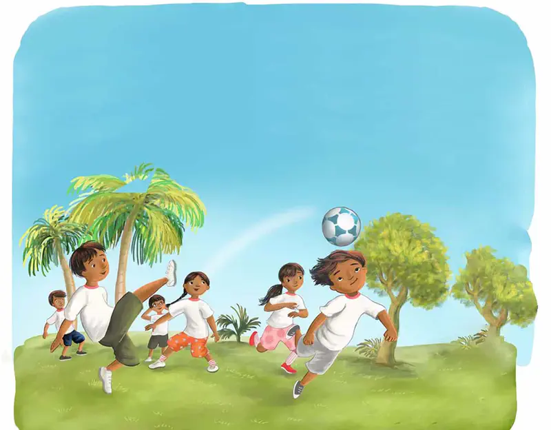 Children in white shirts play soccer on a sunny grassy field with palm trees and green trees, one boy heads the ball while others run and kick.
