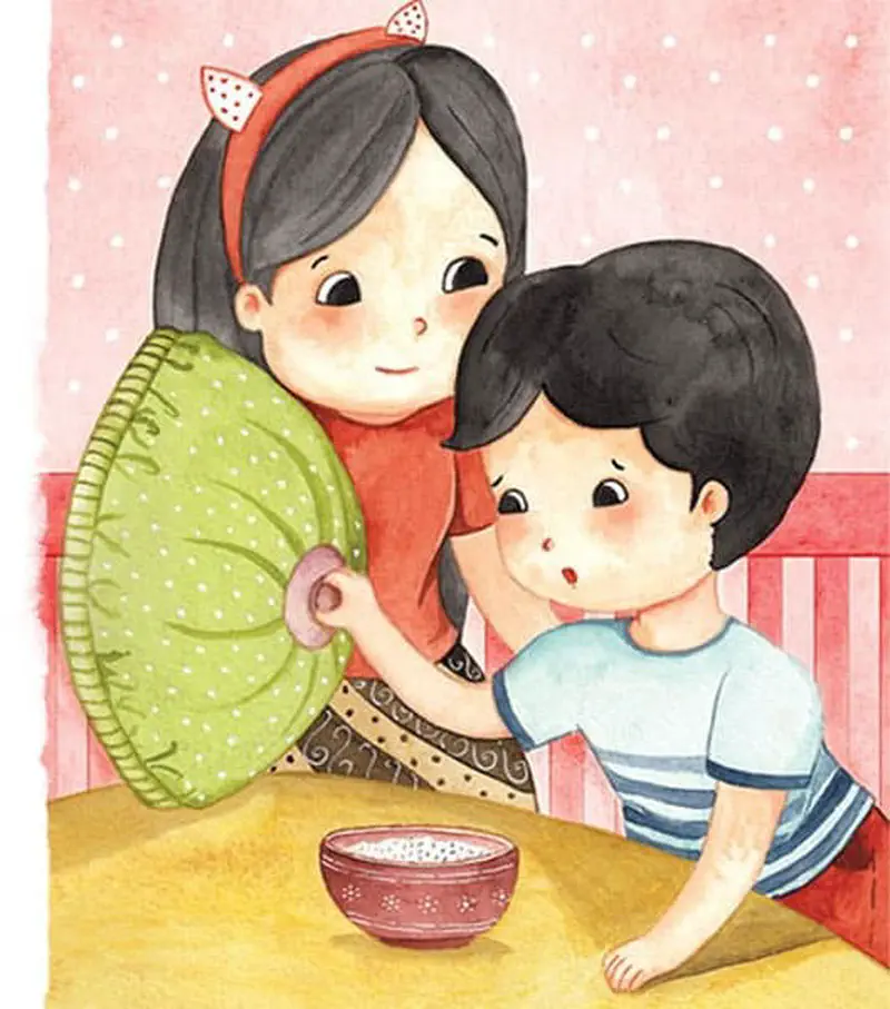 A girl with a cat-ear headband holds a green pillow and comforts a sad boy in a striped shirt sitting at a table with a bowl of food.