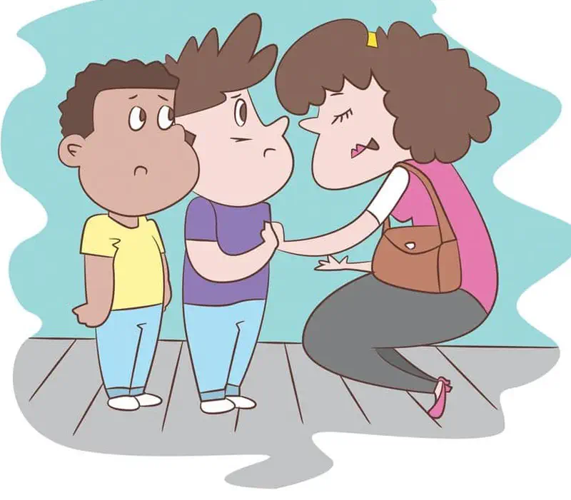 A mother with curly brown hair kneels down to talk to two worried-looking boys, one in yellow and one in purple shirts.