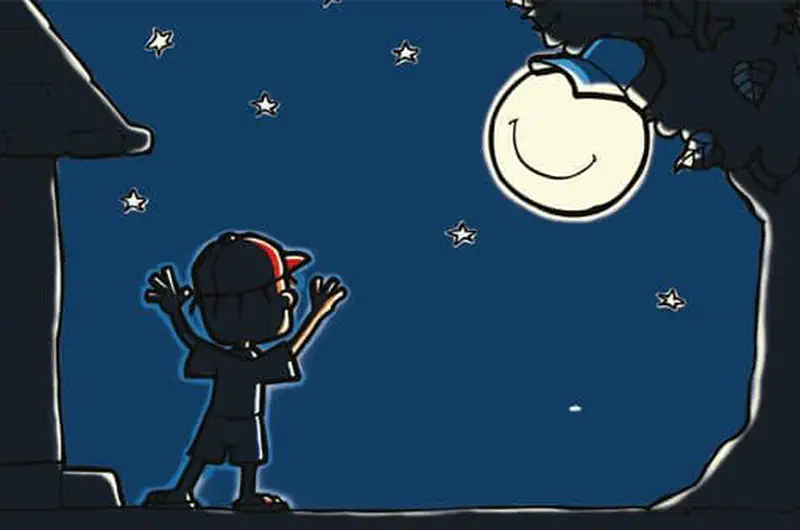 A boy wearing a cap stands outside at night with arms raised, looking up at the smiling moon in a starry sky.