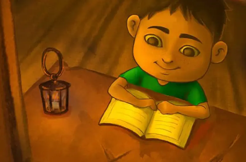A boy in a green shirt reads a book contentedly by the warm glow of an old lantern in a cozy bamboo hut.