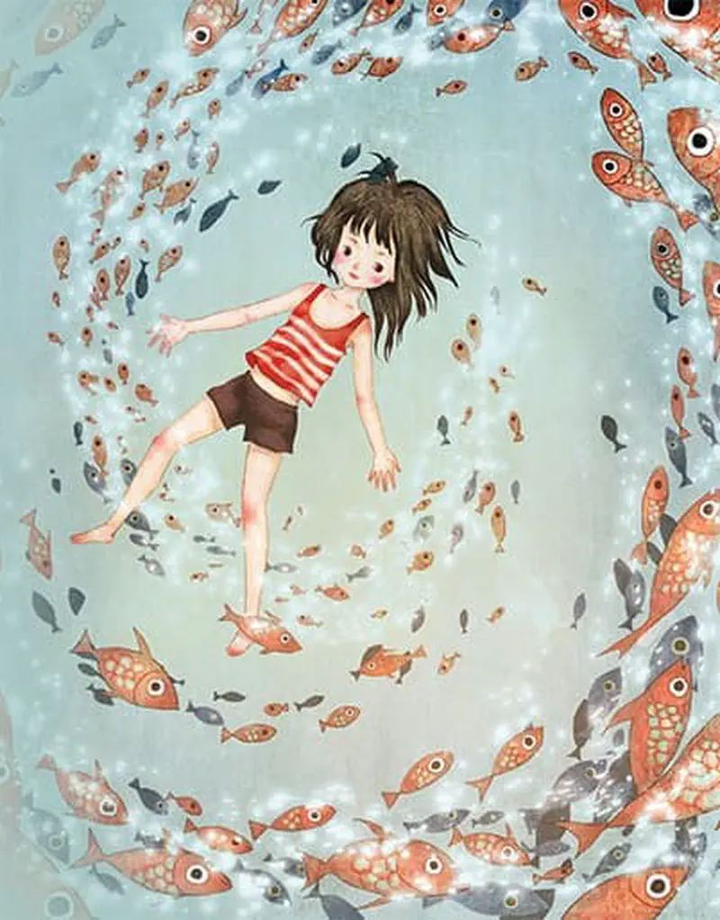 A girl floats in the center of a swirling circle of orange and silver fish swimming around her underwater.