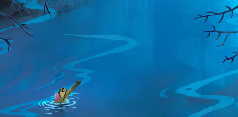 A small crocodile with a pink flower waves while swimming alone in a winding blue river with overhanging branches.