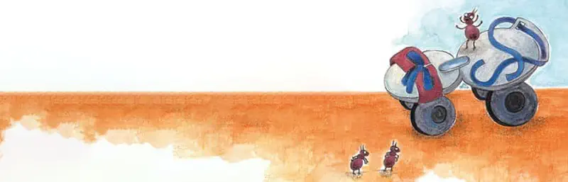 Two ants walk across orange desert sand toward a pair of roller skates, with another ant standing on top of the skates.