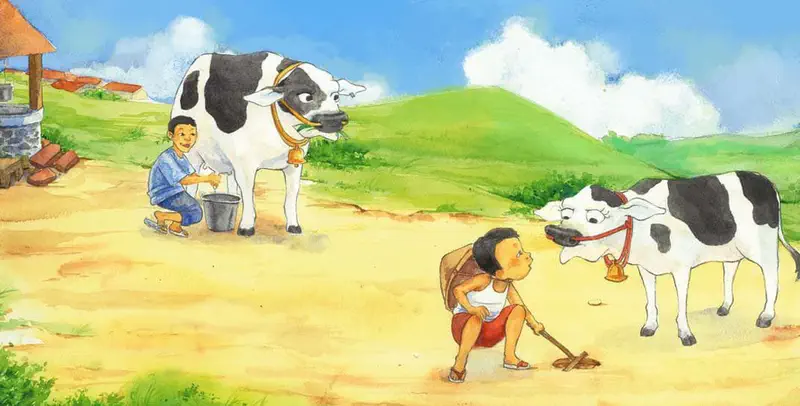 A boy milks a cow near a village while a child in a straw hat sits exhausted on the ground with another cow standing nearby.