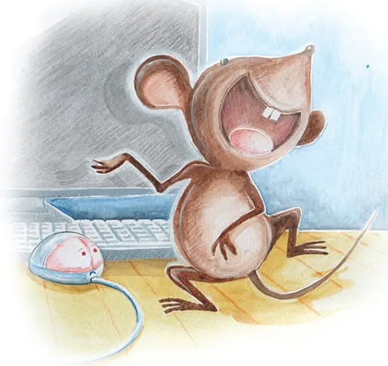 A happy brown mouse laughs joyfully while standing next to a computer mouse on a desk with keyboard and monitor.