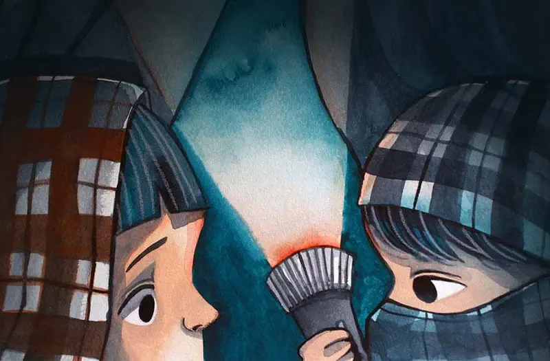 Close-up of two children under checkered blankets in a tent at night, one holding a flashlight that illuminates their curious faces.