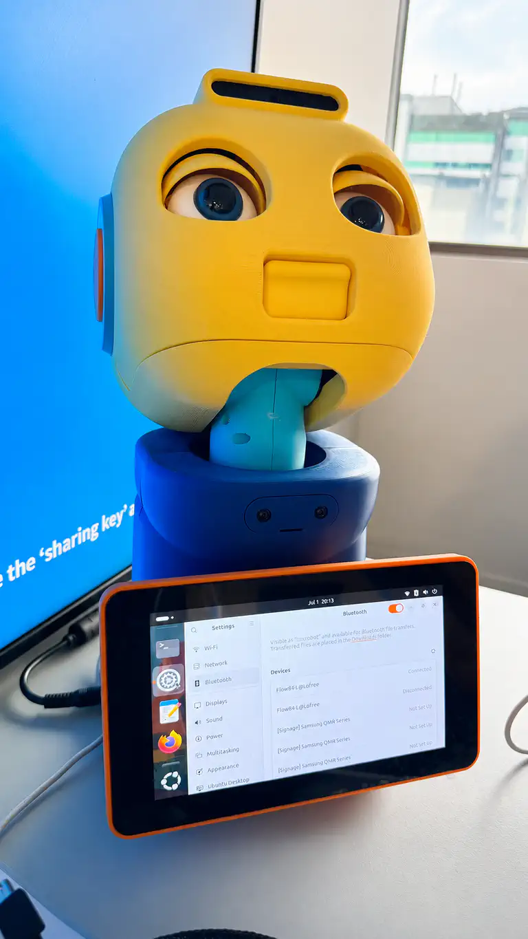 A close-up of Bookbot&rsquo;s face brought to life on the Maki social robot, with a control tablet in front