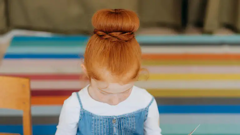 Child reading a book in a library