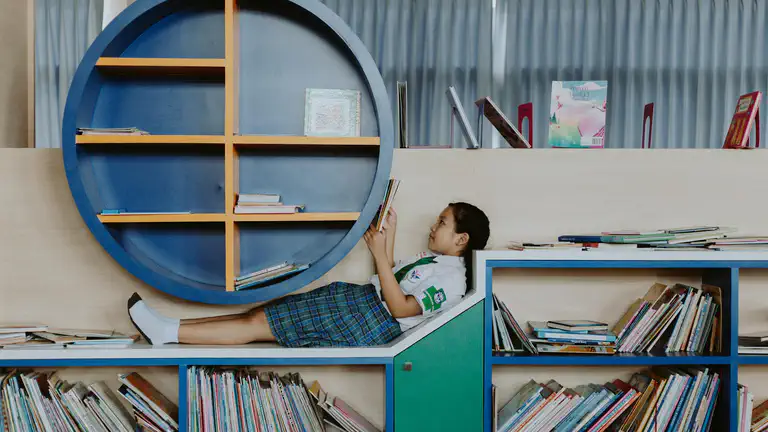 A child listening closely to a bedtime story with a parent